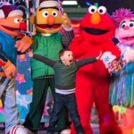 Elmo and Friends greeting a child